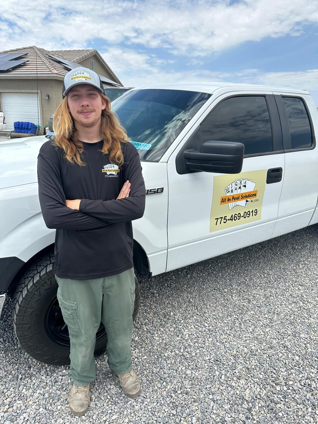 An All In Pest Solutions technician beside a company service truck in Pahrump