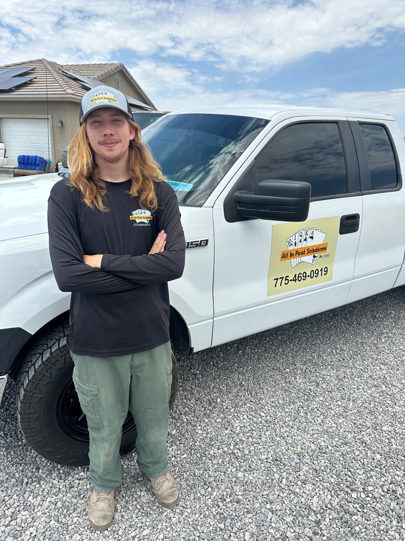 An All In Pest Solutions technician beside a company service truck in Pahrump