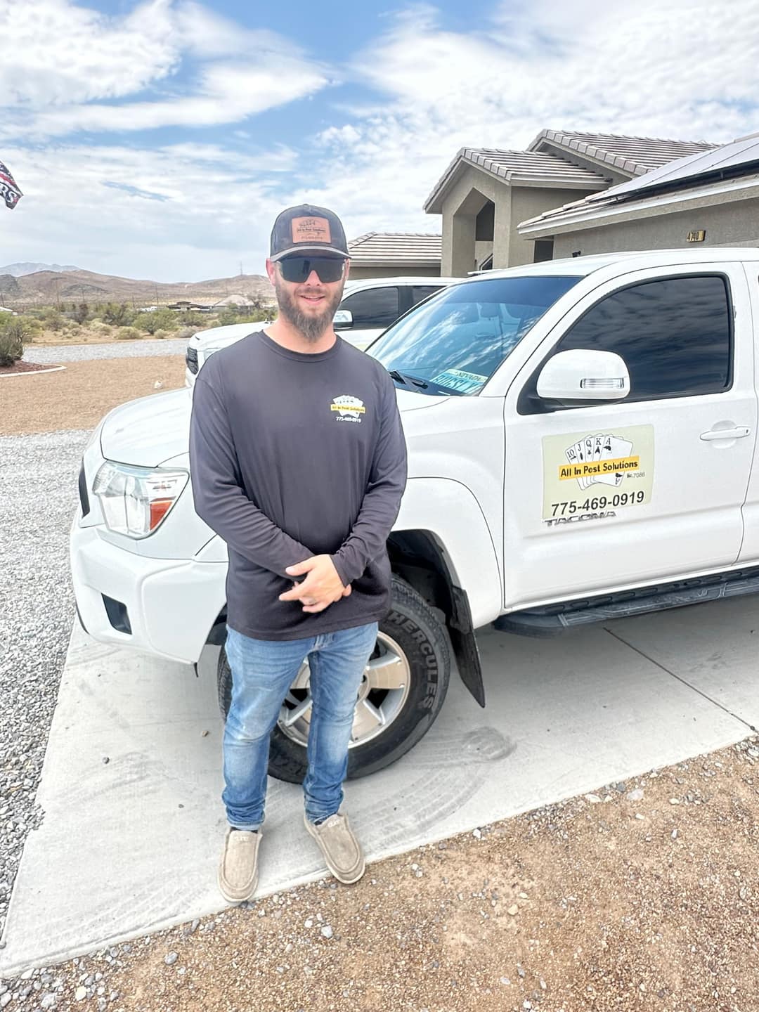 An All In Pest Solutions technician beside a company truck serving Spring Valley